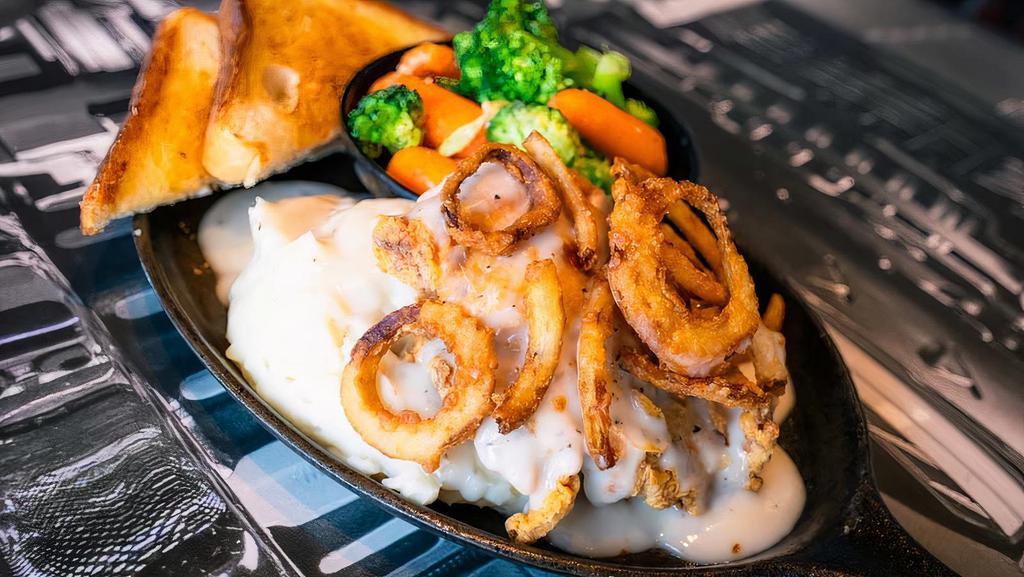 Chicken Fried Chicken Dinner · A generous fresh-fried, crispy chicken fillet topped with country gravy, served with Texas toast, mashed potatoes, and steamed vegetables.