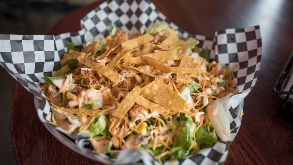 Chicken Fajita Salad · Seasoned chicken breast on a bed of greens with a roasted corn and red pepper mix, cheese, tortilla strips, and spicy ranch dressing.