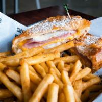 Monte Cristo · Bread layered with tender ham, roasted turkey, Swiss and American cheeses, and mayo. Batter-...