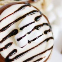 Samoa Cookie · Our Soft Sugar cookie with coconut frosting topped with Chocolate and Caramel Drizzle