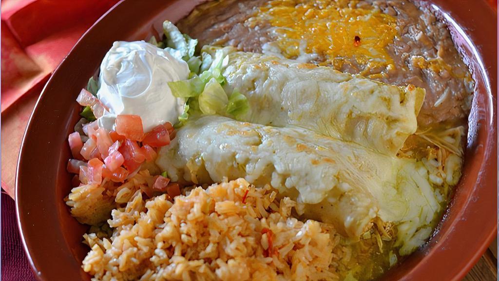 Enchiladas Suizas · Two enchiladas with your choice of picadillo, beef, or chicken. Topped with green salsa, melted cheese, and sour cream.