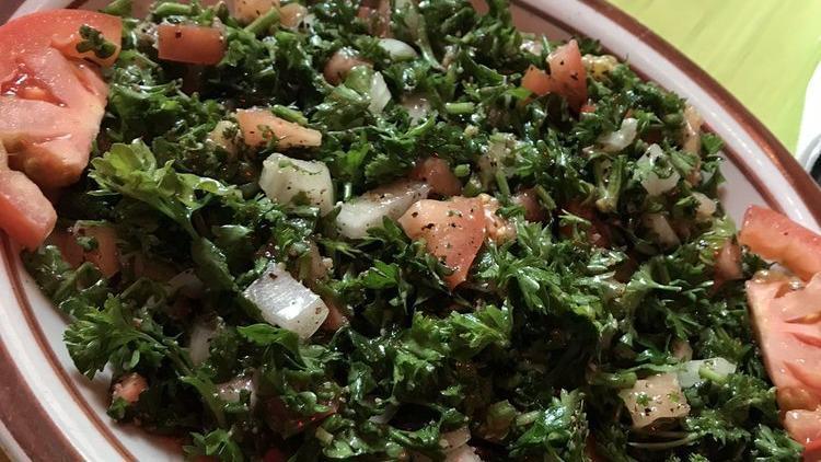 Fattoush Salad · Crisp romaine lettuce, tomato, cucumber, onion, parsley, garlic, lemon juice, and olive oil. Served in a deep fried pita.