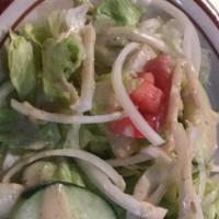 Chicken Salad · Tender marinated chicken on a bed of lettuce with tomato, cucumber, onions, and parsley in h...