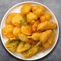 Pakoras Of Being A Wall Flower · A popular Indian street food! Fresh vegetables, coated in spiced gram flour and deep fried.