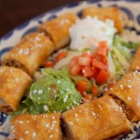 Taquitos · Flour tortilla filled with cheese and choice of chicken, picadillo or veggie. Lightly fried ...