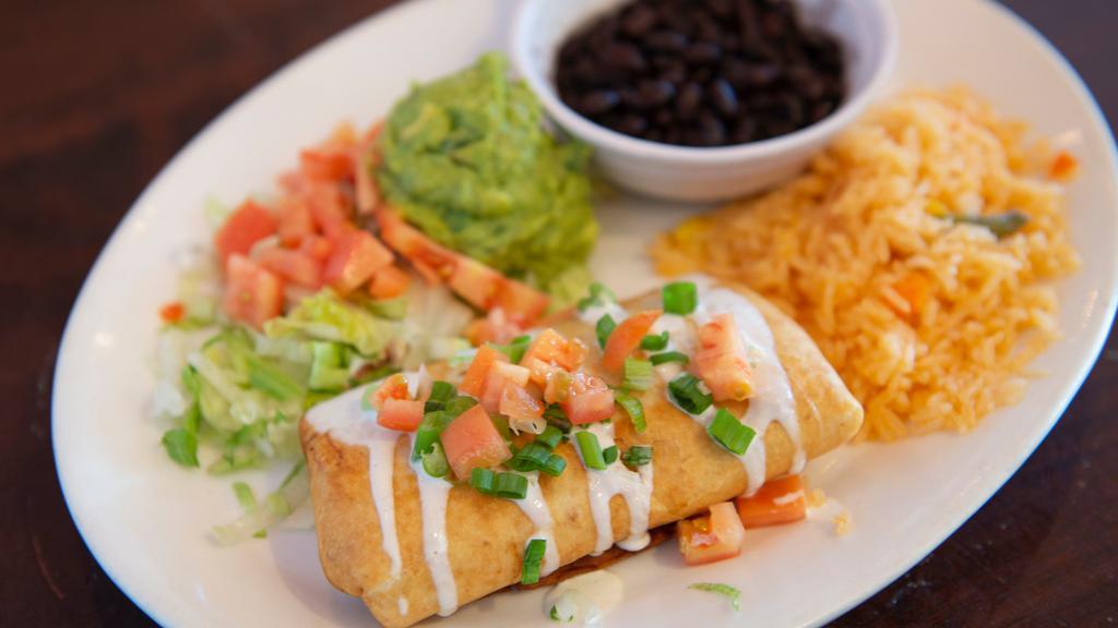 P/P Chimichanga · Crispy Flour tortilla filled with choice of protein or veggie. Fried crispy and topped with sour cream, guacamole, green onions and tomatoes. Served with rice and beans.