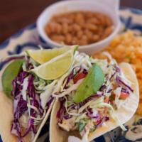 Baja Fish Tacos · Two flour or corn tortillas filled with wild Alaskan cod lightly fried in our negra modelo b...