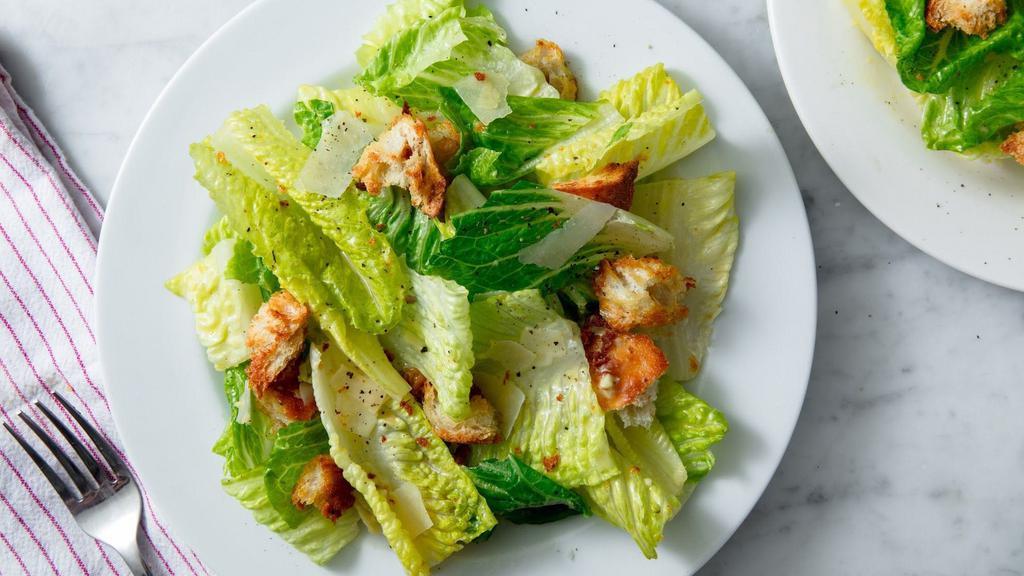 Caesar Salad · Romaine lettuce, Parmesan, torn croutons & Caesar dressing.