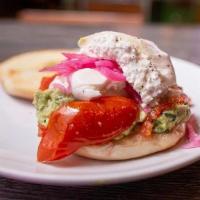 Avo Bagel · Smashed avocado, sea salt, red onion, roasted tomatoes, burrata cheese on the classic bagel