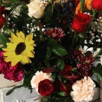 Sangre De Cristo · Wildflower retreat with roses (selection varies ) the arrangement pictured used red and crea...