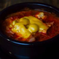 Hot Pot Army Stew (뚝배기 부대찌개) · Spicy soup with a kimchi base. It has onions, green onions, ham, sausage, cheese and pork. Y...