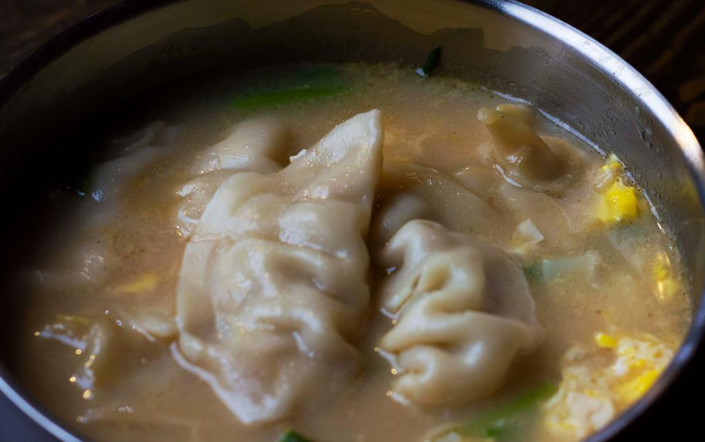 Dumpling Soup (만두국) · Soup with pork dumplings, egg, green onions. Rice cakes can be added for an extra charge. It comes with rice and side dishes.