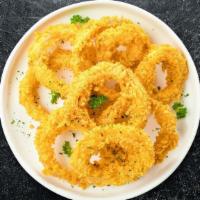 Onion Crunch · Sliced onions dipped in a light batter and fried until crispy and golden brown.