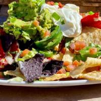 Bistro Nachos · Corn tortilla chips smothered in queso blanco, topped with fresh jalapenos, pico de gallo,
l...