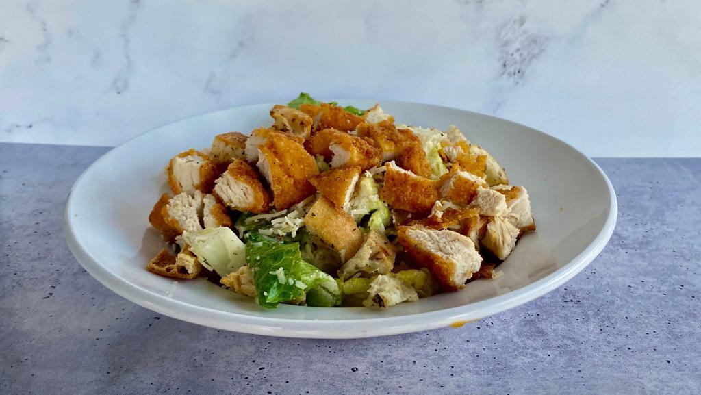 Crispy Chicken Caesar · Romaine, crispy chicken, caesar dressing, Parmesan and croutons.