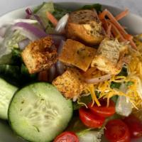 Classic · Romaine with shredded cheese, cucumber, tomato, red onion, carrot, and croutons with a choic...