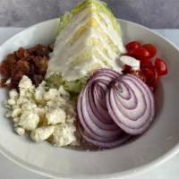 Wedge · Iceberg wedge, bacon, red onion, tomato, bleu cheese crumbles and bleu cheese dressing.