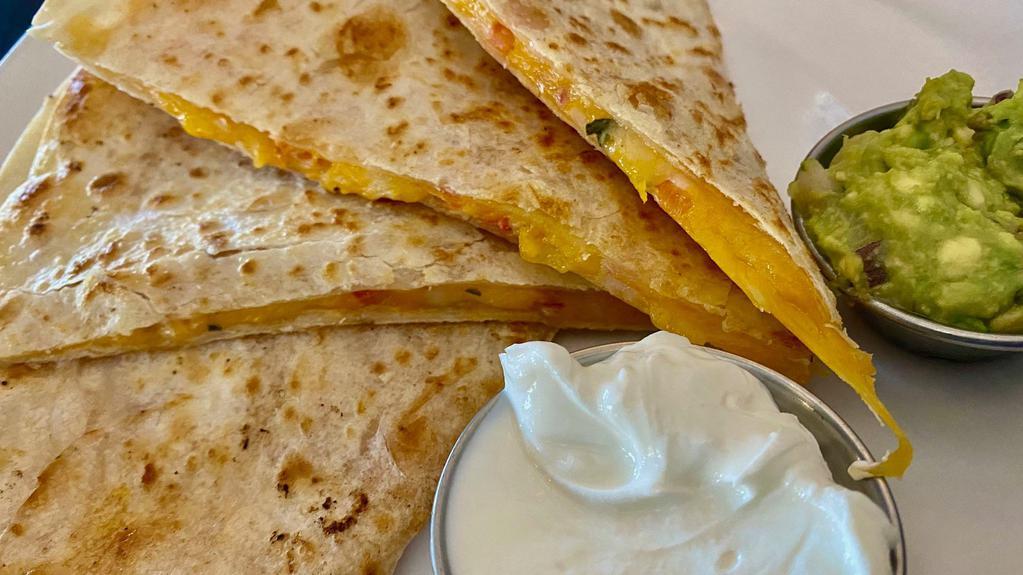 Quesadilla · Flour tortilla stuffed with shredded cheddar jack cheese, pico de gallo, served with salsa, sour cream, and guacamole.