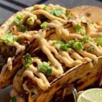 Carnitas · Two tacos topped with a cilantro-lime cabbage mix, green onion, and chipotle aioli.