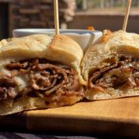 French Dip · Shaved prime rib with swiss on a french roll served with au jus and creamy horseradish.