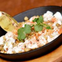 Mexican Grilled Corn · Mexican street corn, grilled with cotija cheese, crema, chile spice, cilantro