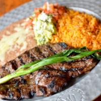 Carne Asada · Our famous skirt steak seasoned with our proprietary spices served with guacamole, pico de g...