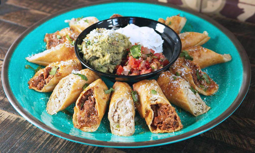 Crispy Flautas Platter · 15 Flautas (30 Halves). Rolled crispy flour tortills filled with jack cheese and seasoned chicken or shredded beef. Includes guacamole and sour cream