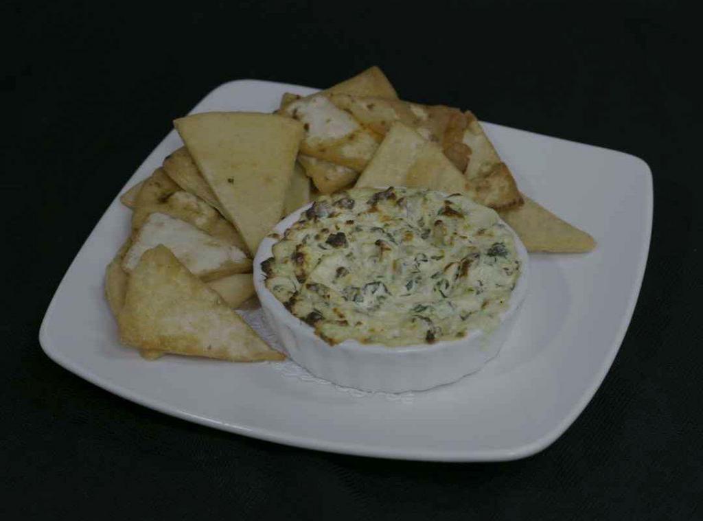 Artichoke Cheese Dip · Creamy blend of cheese, artichoke hearts, baby spinach, caramelized onion & red peppers, served with pita chips