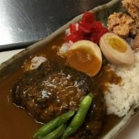 Deluxe Curry · Curry rice with chicken karaage, hamburger patty, soft boiled egg and vegetables.