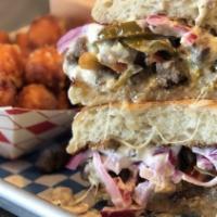 Steak Beastie Sandwich · Carne Asada, hot peppers, pickled onion, provolone, and rosemary aioli on a Telera roll.