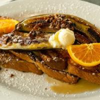 Griddled French Toast · Dipped in our banana cinnamon cream with candied pecans, grilled banana.  Served with butter...