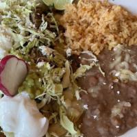 Vampiros · Layered soft corn tortillas, bottom topped with refried beans and melted Monterrey cheese. C...