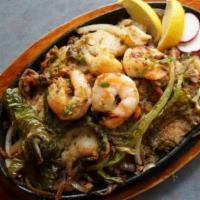 Parrillada Del Mar · Marinated basa fillet, shrimp, prawns, and scallops over grilled onions, roasted jalapenos, ...