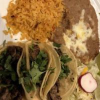 Street Tacos · (Three) mini tacos with your choice of steak, grilled chicken, or carnitas. Topped with fres...