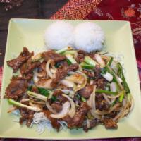 C1 Mongolian Beef · Sliced beef with green onion on white rice.