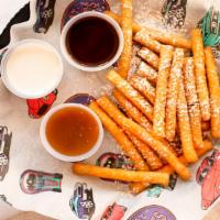 Funnel Cake Bites · Funnel Cake Fries - Sprinkled with powered sugar & Served with three dipping sauces.