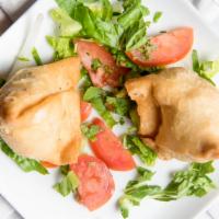 Vegetable Samosa · Deep fried patties stuffed with spiced potatoes and green peas.