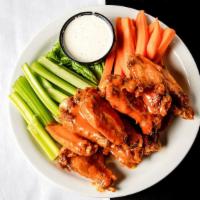 Chicken Wings · Perfectly seasoned and fried tossed with your choice of sauce and served with celery and car...
