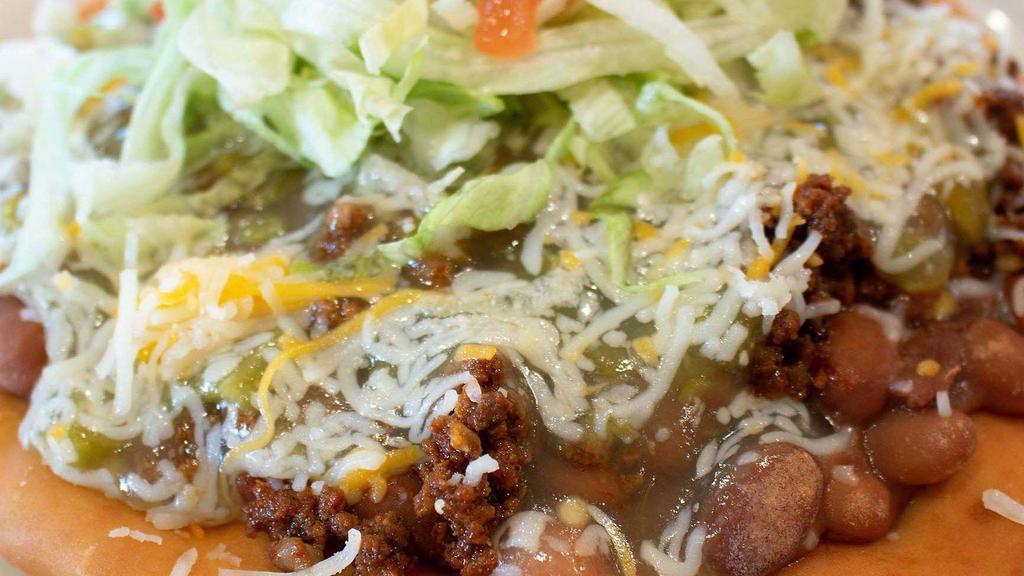 Indian Taco · Indian Fry bread with choice of meat and chili, beans, cheese, lettuce, and tomato.