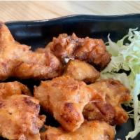 Chicken Kara-Age · Deep-fried Japanese style marinated chicken thigh with lemon on the side.