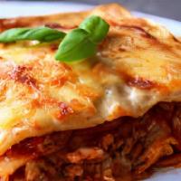 Lasagna Fiorentina · Lasagna layers with meat sauce and bechamel.