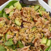 Deliziosa · Organic: green mix tomatoes and cucumbers walnuts smoked salmon house made green goddess dre...