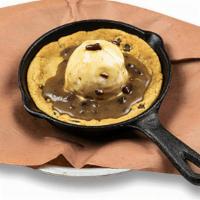 Skillet Cookie · A gooey Chocolate Chip Cookie topped with a scoop of Vanilla Ice Cream and Praline Sauce.
