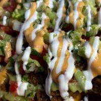 Birria Fries · Steak fries deep fried to perfection and topped with Birria meat, nacho cheese, tomato, raw ...