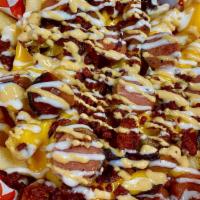 Salchipapas · French fries topped with sliced hot dogs, nacho cheese, chipotle mayo and ranch
