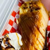 Caramel Cheesecake · Slice of Caramel Cheesecake with scoop of ice cream, whipping cream, chocolate and caramel d...