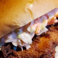 Chicken Sandwich · Our house made chicken sandwich! Whole breaded chicken thigh with coleslaw on top of a brioc...