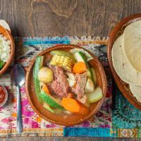 Caldo De Res · Satisfying soup, made with beef bones, carrots, cabbage, potatoes, corn, chayote, and Mexica...