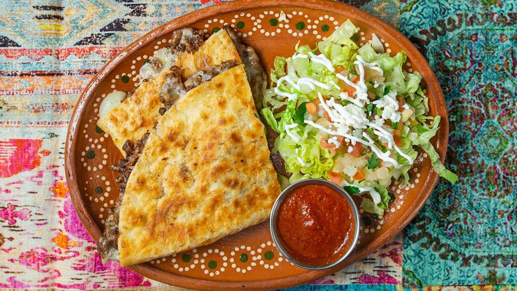 Quesadillas · Flour tortilla, loaded with our blend of cheeses and your choice of meat.