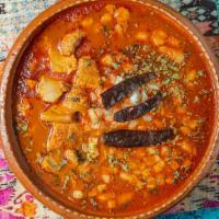 Menudo · Traditional Mexican soup, made with cow stomach (tripe) in broth with a red chili pepper bas...